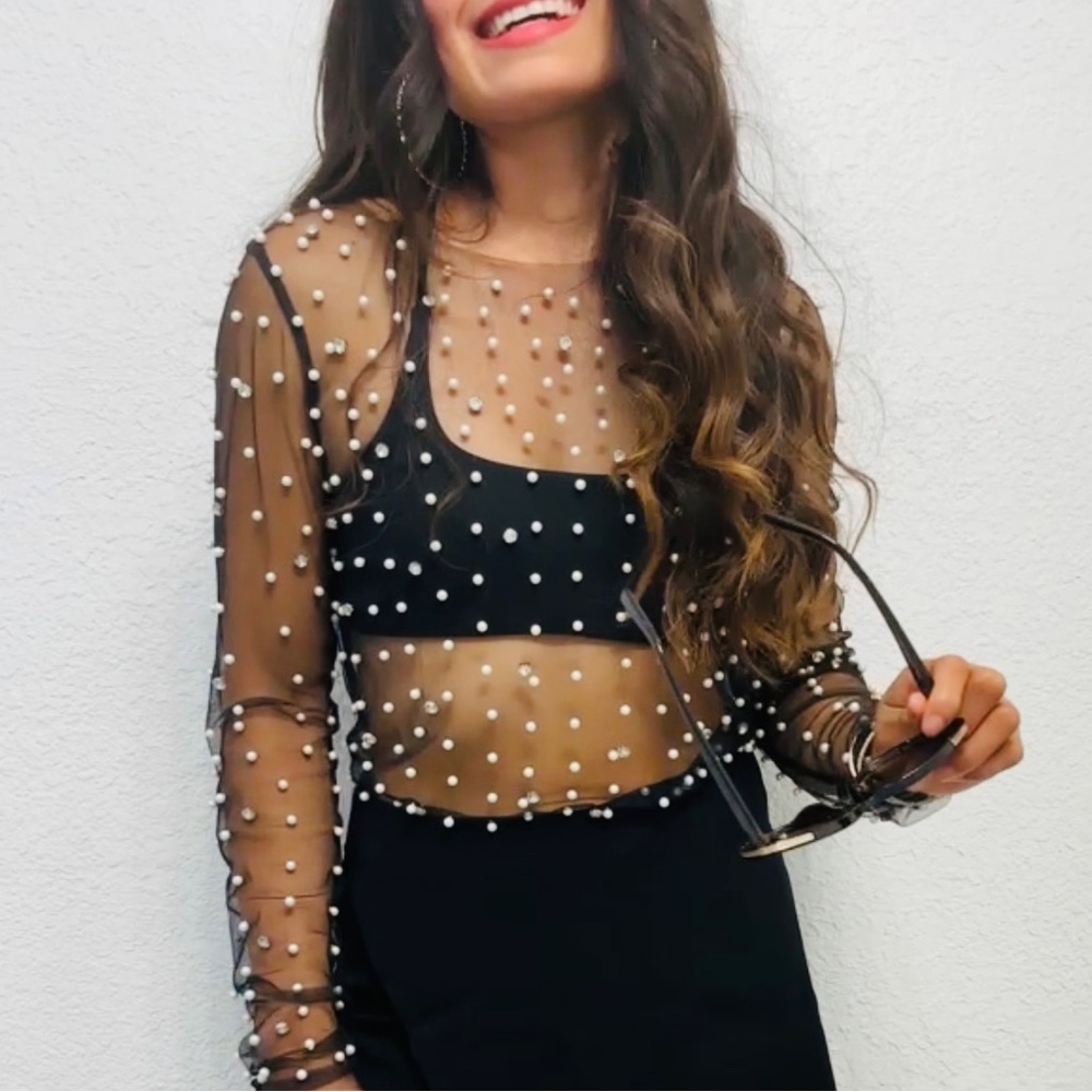 Long sleeve sheer pearl mesh black top.